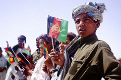 GARMSIR DISTRICT, Helmand province, Afghanistan â€” Local children wave Afghan flags during a gift handout in support of the local communityâ€™s celebration of Eid here, Aug. 31. Marines, with 1st Battalion, 3rd Marine Regiment, partner with Afghan National Security Forces to provide security in the district and handout gifts in support of the three-day, Islamic holiday of Eid Il-Iftar, or â€˜to break the fast.â€™